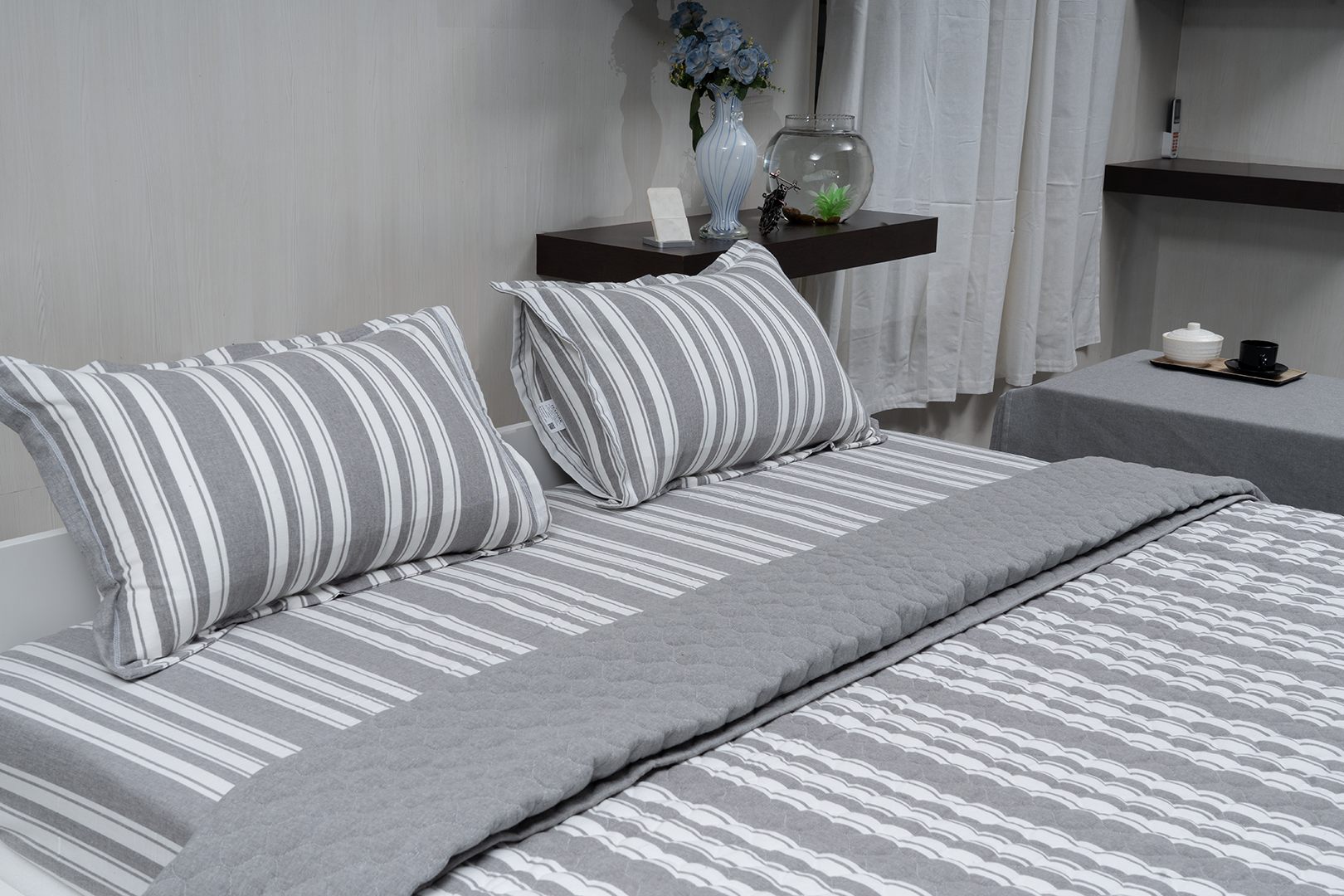 Linn Decors fitted sheet with two pillow covers and quilt styled on a modern bedroom bed