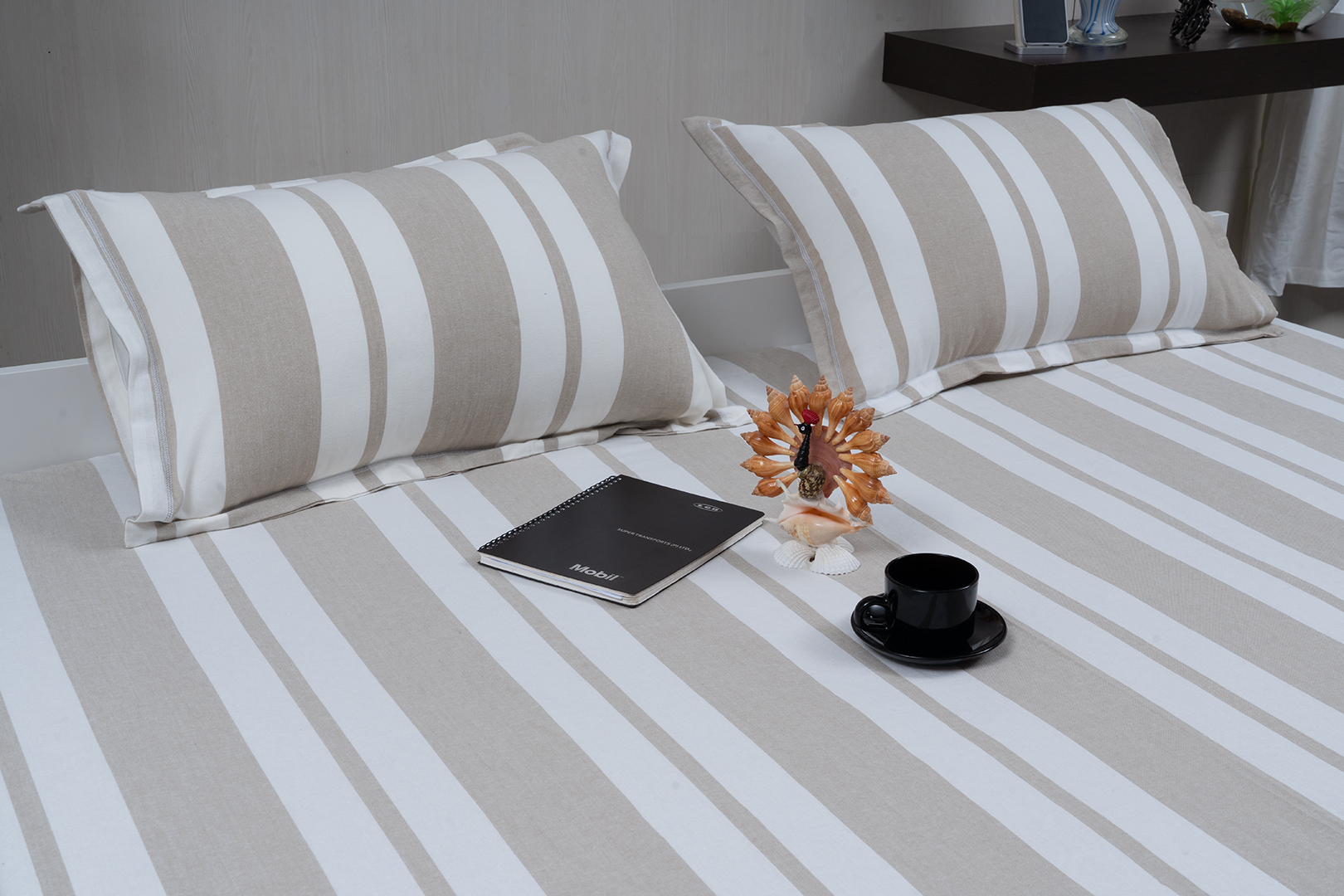 Linn Decors fitted sheet with two pillow covers and quilt styled on a modern bedroom bed
