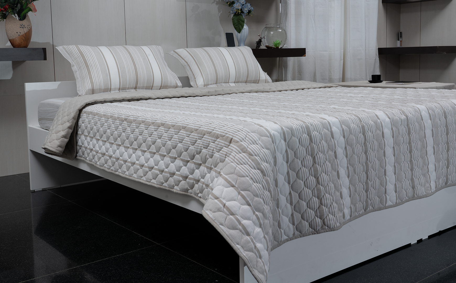 Linn Decors fitted sheet with two pillow covers and quilt styled on a modern bedroom bed