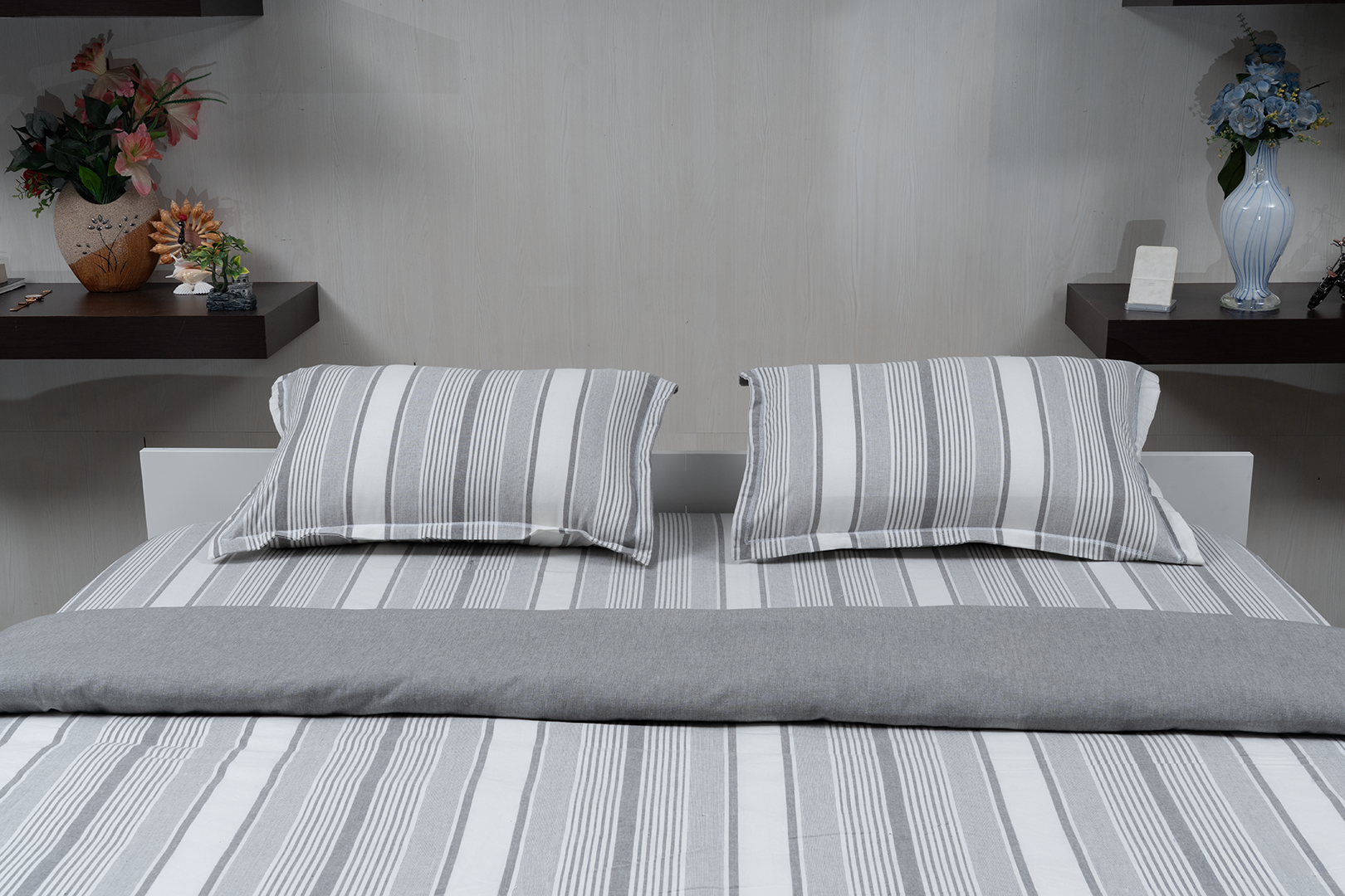 Linn Decors fitted sheet with two pillow covers and quilt styled on a modern bedroom bed