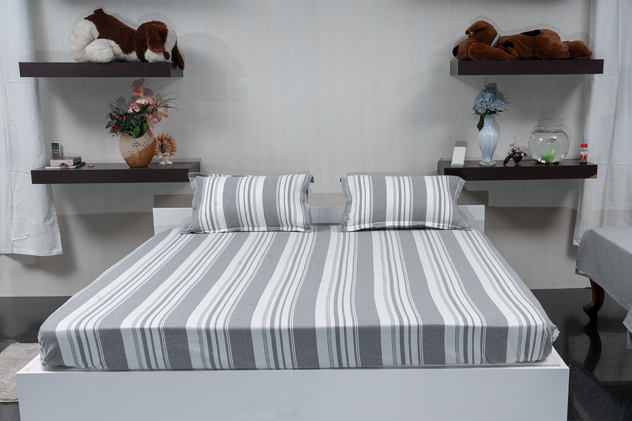Linn Decors fitted sheet with two pillow covers and quilt styled on a modern bedroom bed