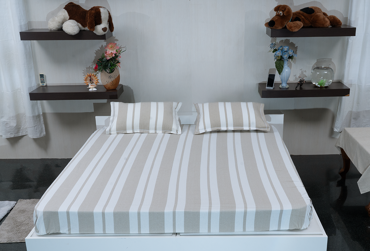 Linn Decors fitted sheet with two pillow covers and quilt styled on a modern bedroom bed