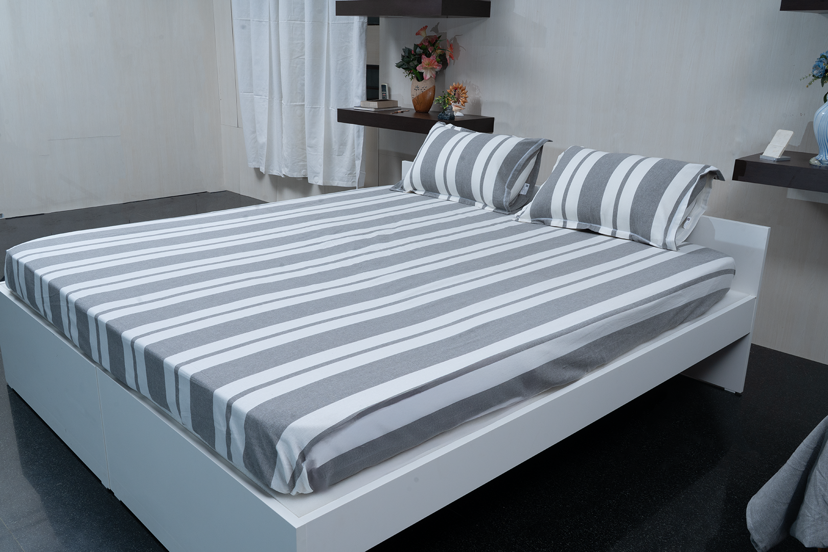 Linn Decors fitted sheet with two pillow covers and quilt styled on a modern bedroom bed