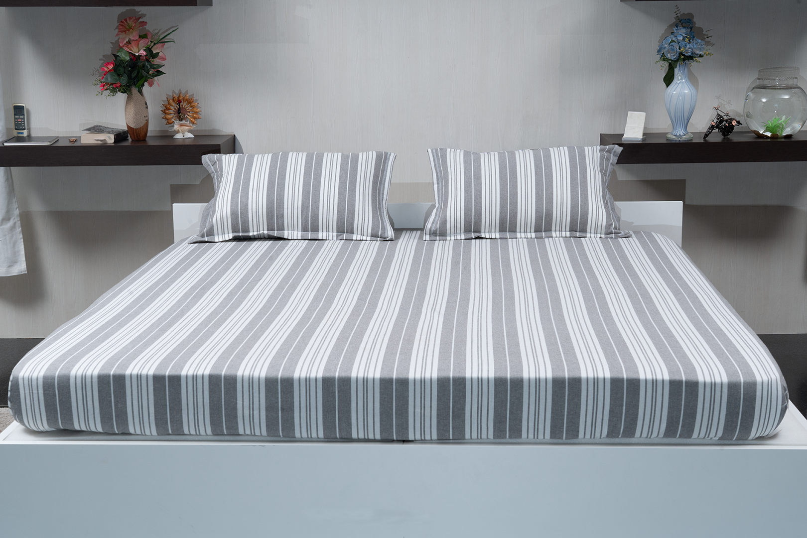 Linn Decors fitted sheet with two pillow covers and quilt styled on a modern bedroom bed