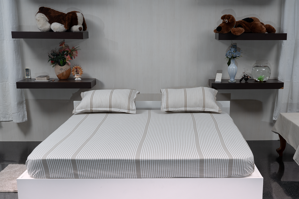 Linn Decors fitted sheet with two pillow covers and quilt styled on a modern bedroom bed