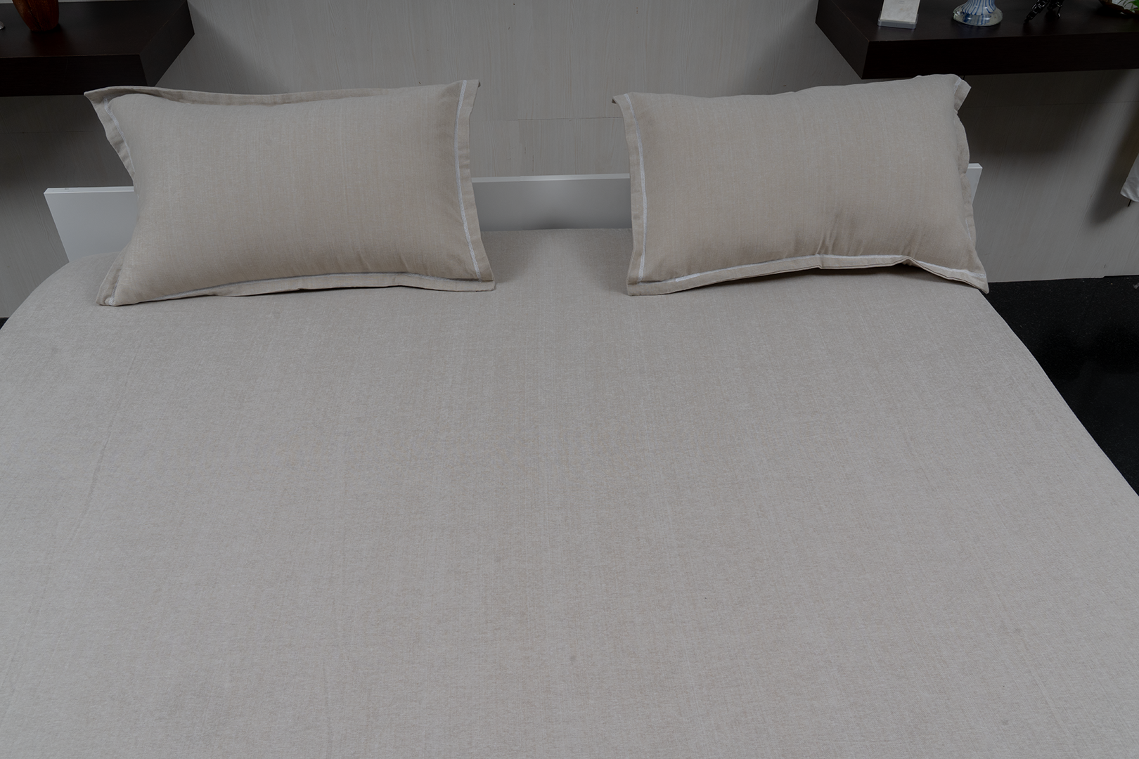 Linn Decors fitted sheet with two pillow covers and quilt styled on a modern bedroom bed