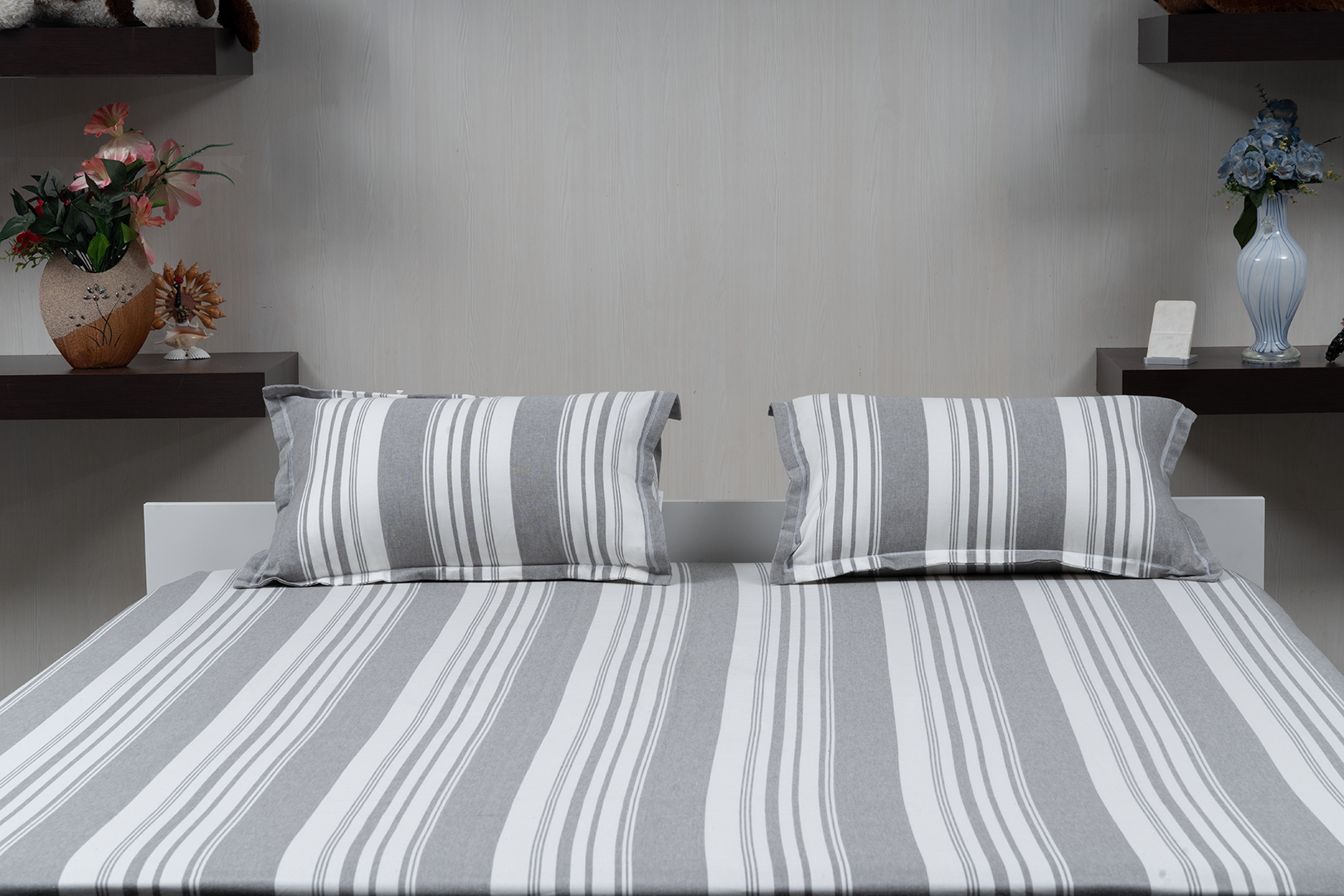 Linn Decors fitted sheet with two pillow covers and quilt styled on a modern bedroom bed