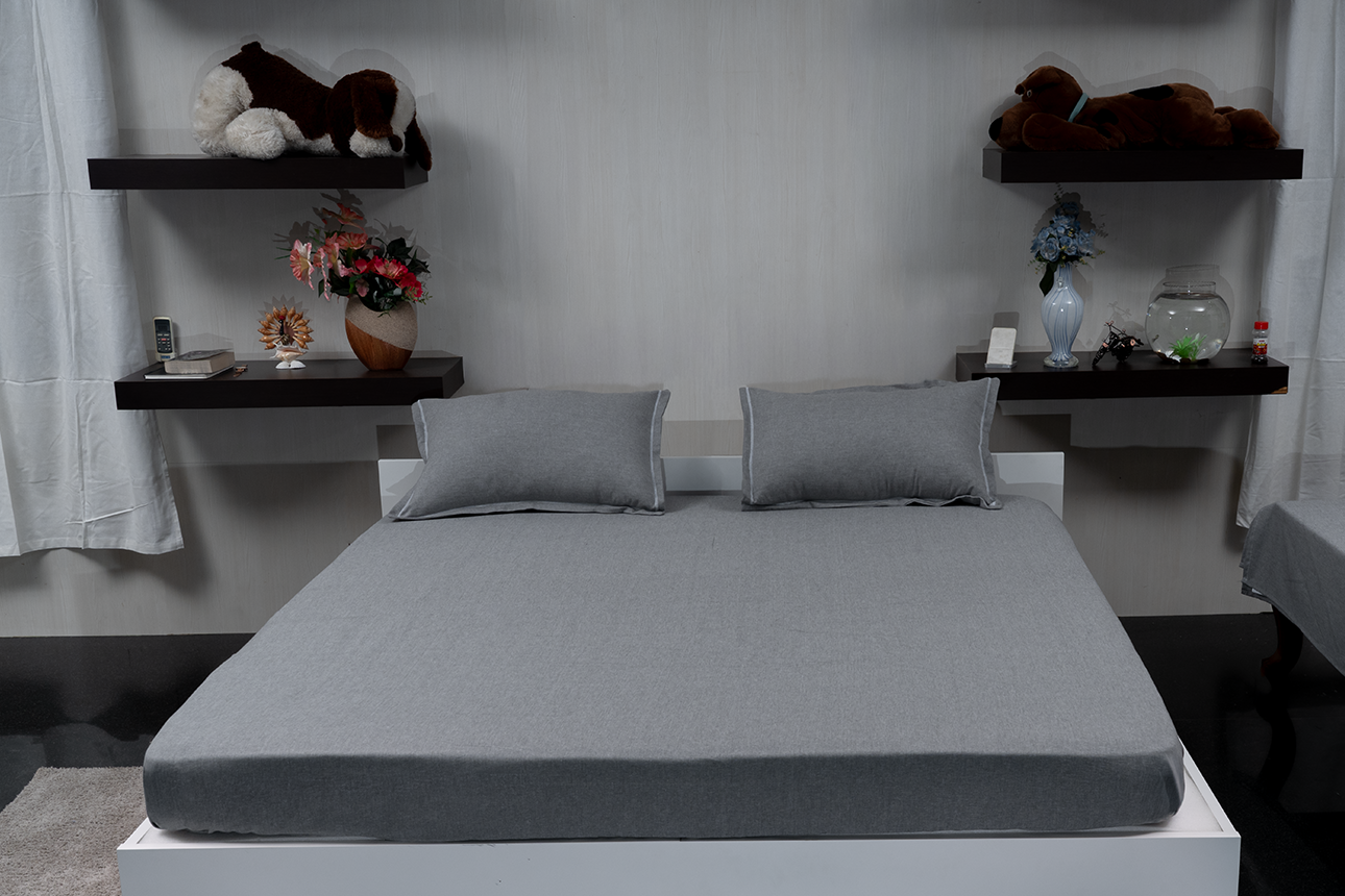 Linn Decors fitted sheet with two pillow covers and quilt styled on a modern bedroom bed