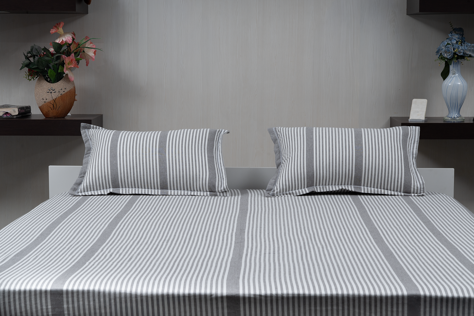 Linn Decors fitted sheet with two pillow covers and quilt styled on a modern bedroom bed