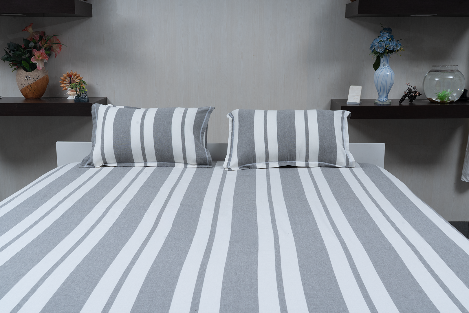 Linn Decors fitted sheet with two pillow covers and quilt styled on a modern bedroom bed
