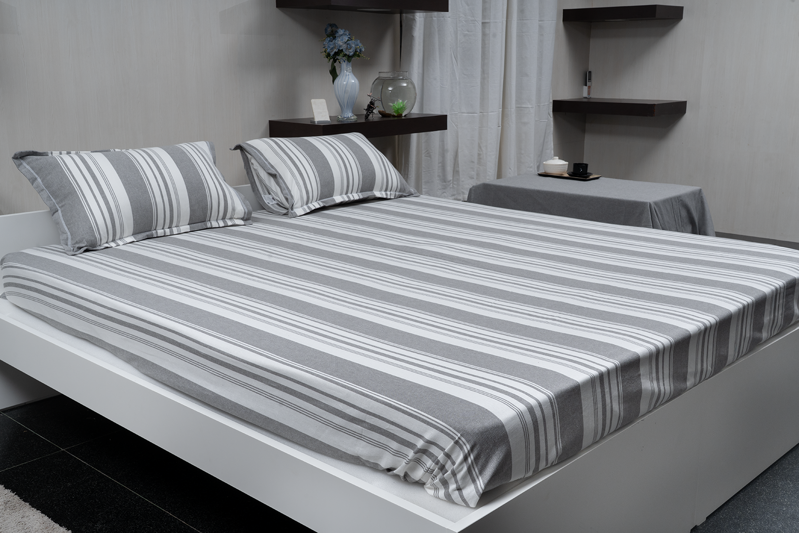 Linn Decors fitted sheet with two pillow covers and quilt styled on a modern bedroom bed