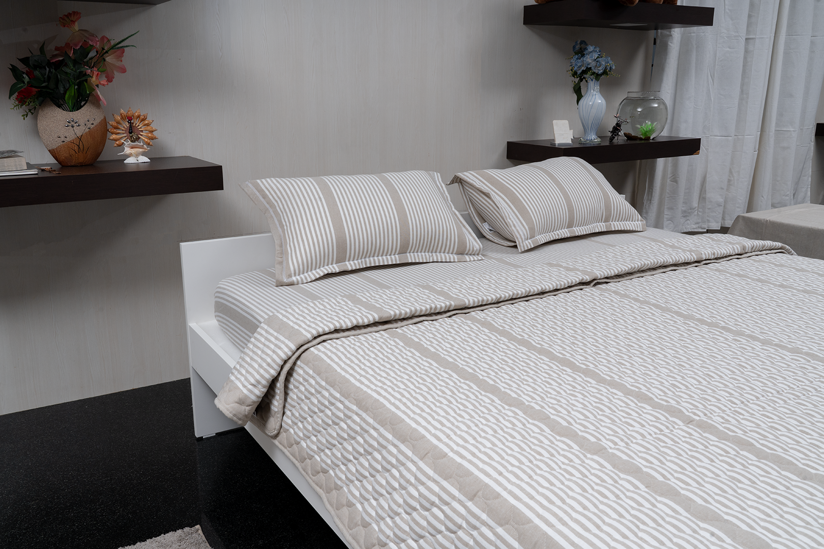 Linn Decors fitted sheet with two pillow covers and quilt styled on a modern bedroom bed