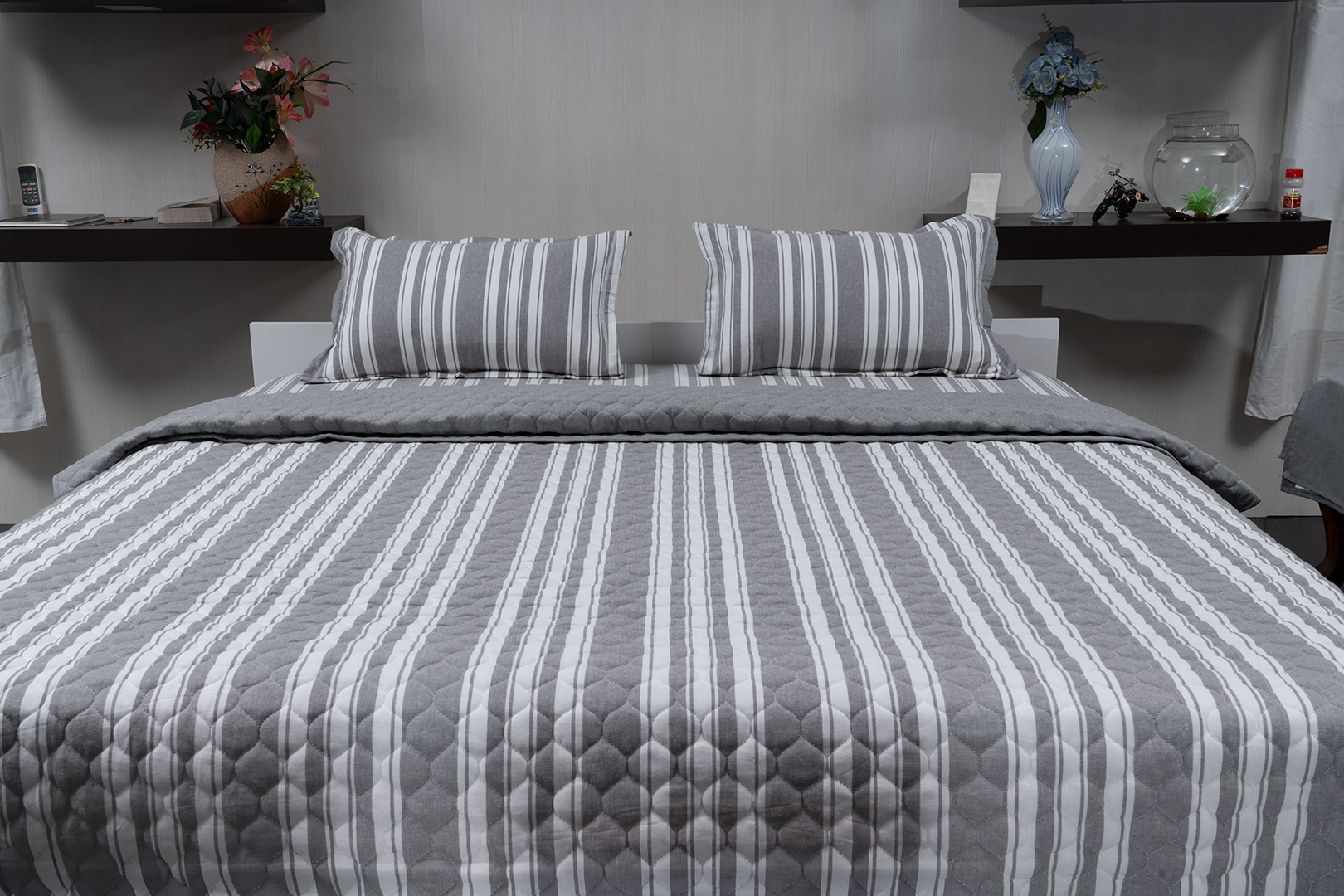 Linn Decors fitted sheet with two pillow covers and quilt styled on a modern bedroom bed