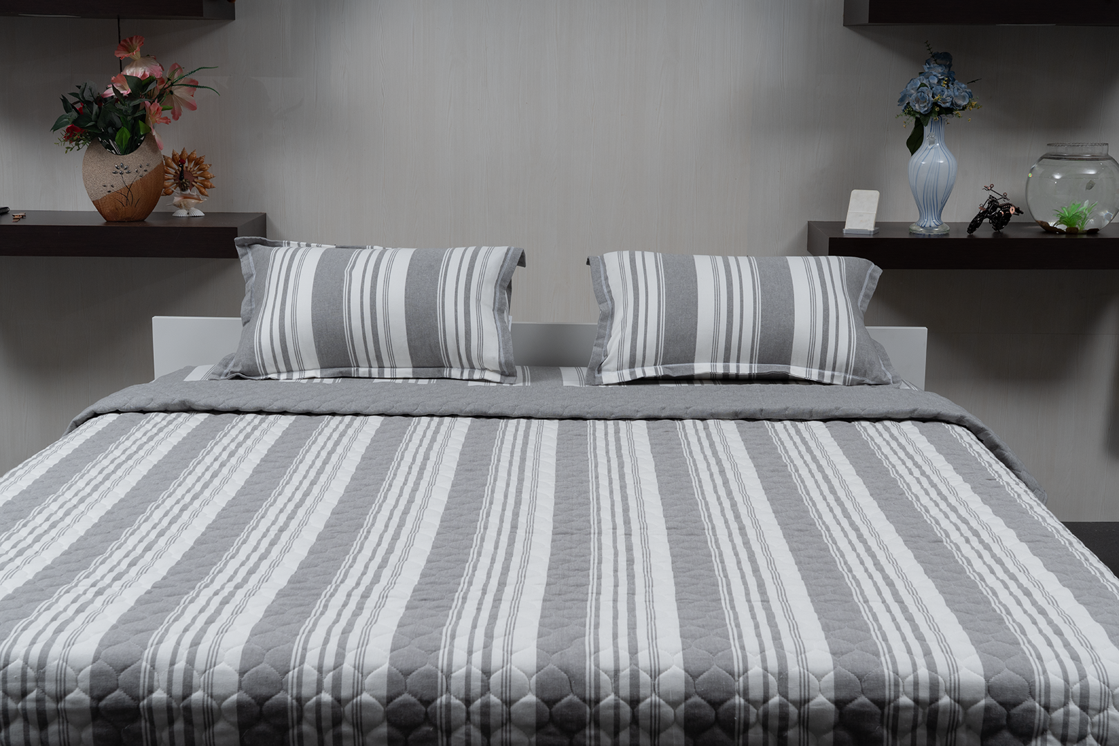 Linn Decors fitted sheet with two pillow covers and quilt styled on a modern bedroom bed