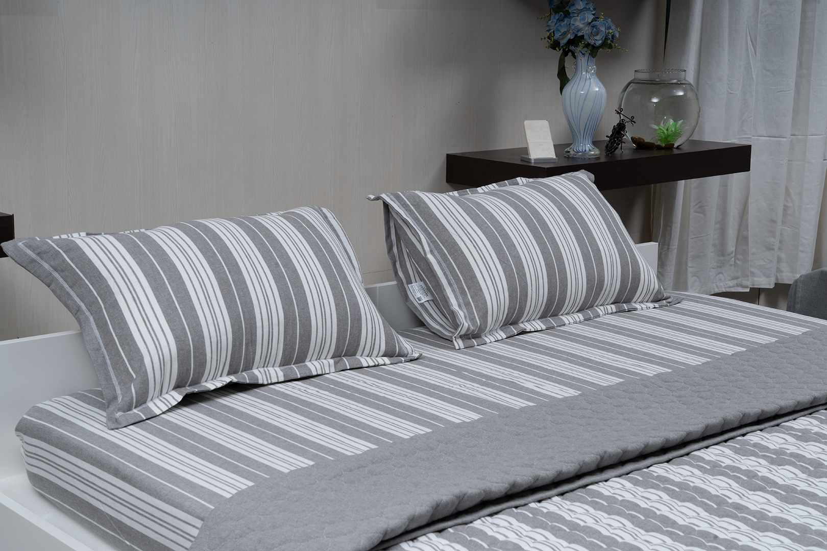 Linn Decors fitted sheet with two pillow covers and quilt styled on a modern bedroom bed