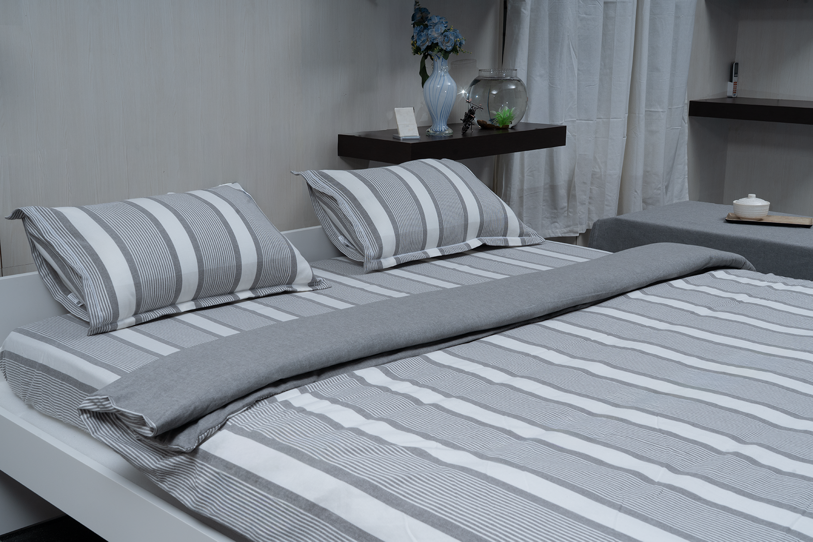 Linn Decors fitted sheet with two pillow covers and quilt styled on a modern bedroom bed
