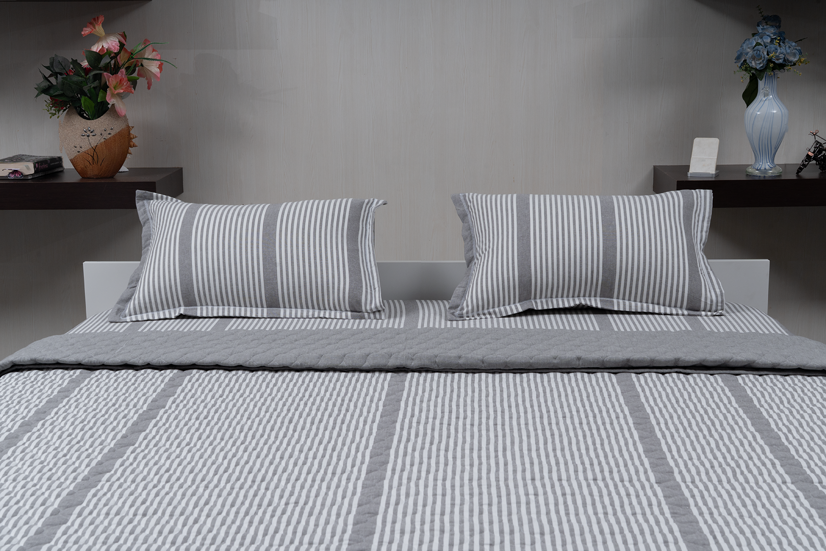 Linn Decors fitted sheet with two pillow covers and quilt styled on a modern bedroom bed