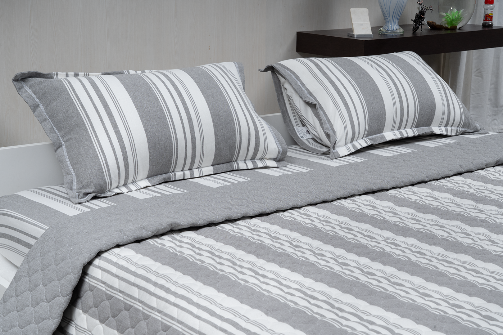 Linn Decors fitted sheet with two pillow covers and quilt styled on a modern bedroom bed