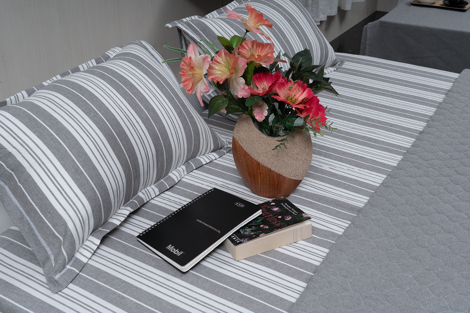 Linn Decors fitted sheet with two pillow covers and quilt styled on a modern bedroom bed