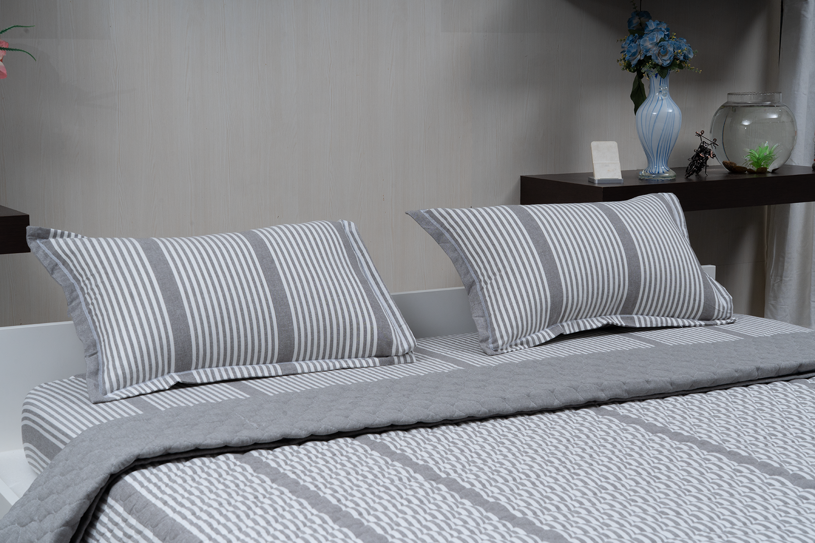Linn Decors fitted sheet with two pillow covers and quilt styled on a modern bedroom bed