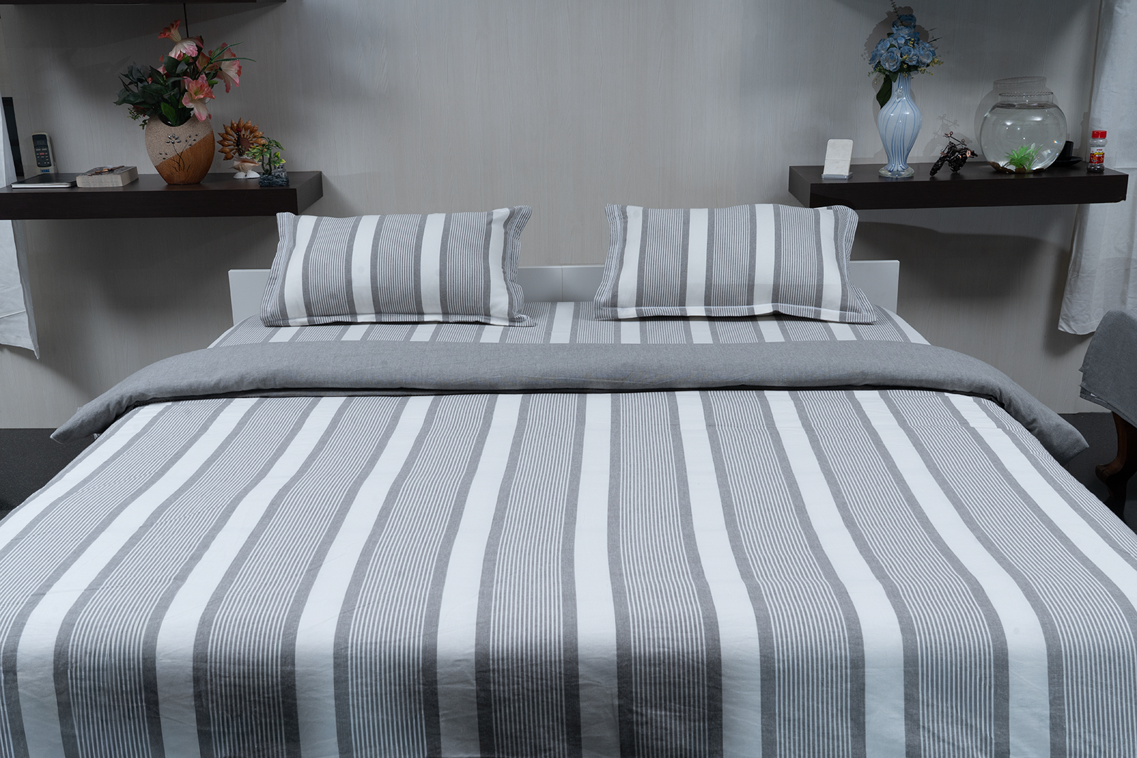 Linn Decors fitted sheet with two pillow covers and quilt styled on a modern bedroom bed