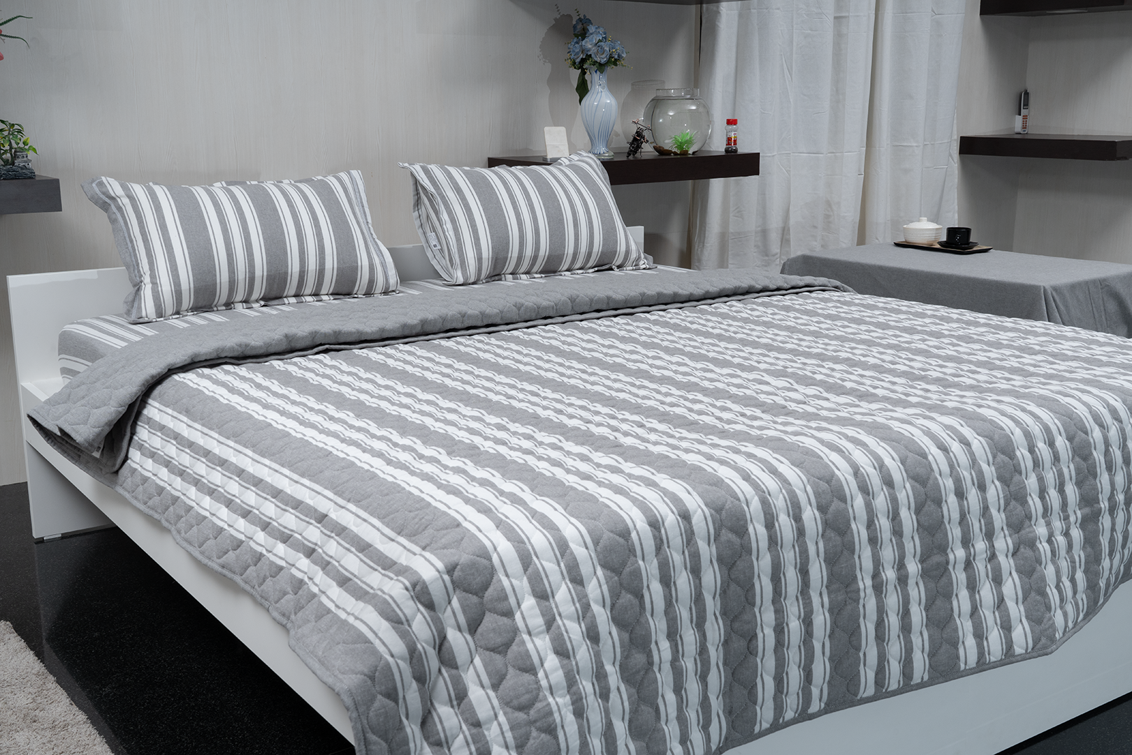 Linn Decors fitted sheet with two pillow covers and quilt styled on a modern bedroom bed