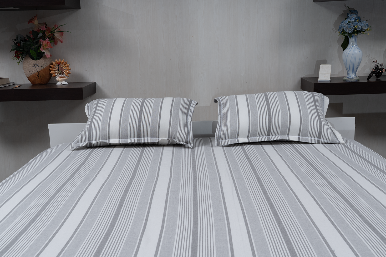 Linn Decors fitted sheet with two pillow covers and quilt styled on a modern bedroom bed