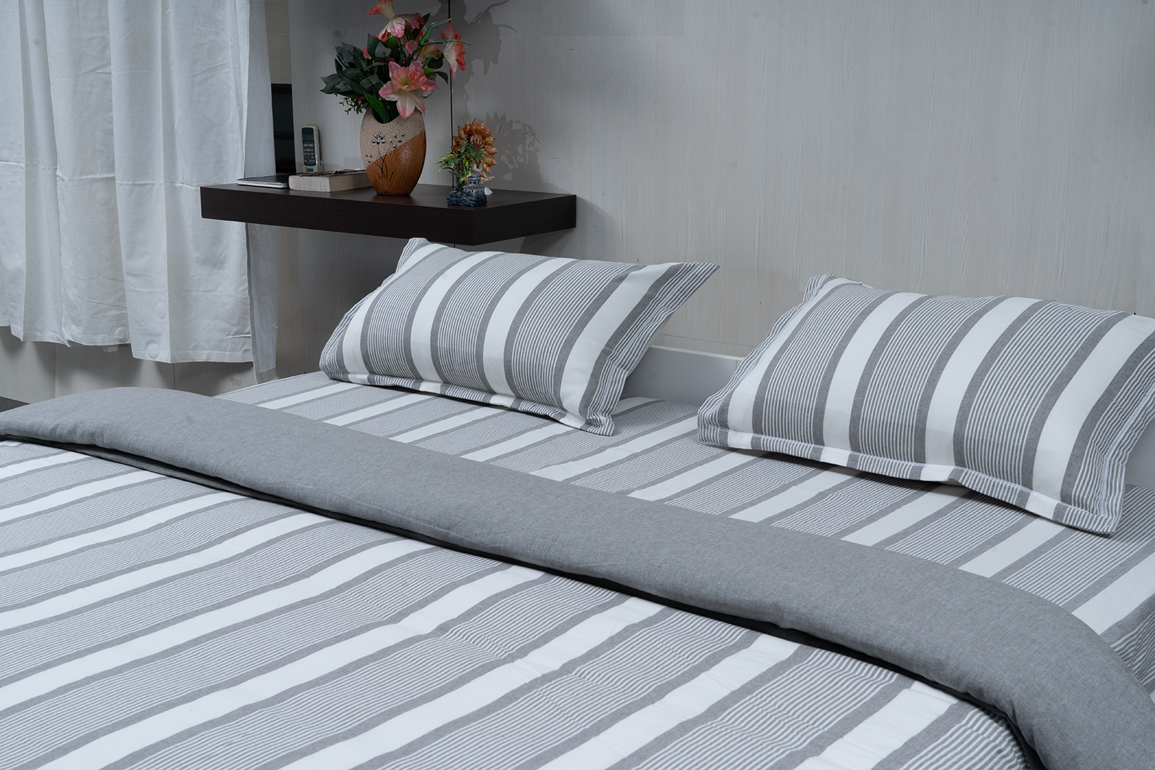 Linn Decors fitted sheet with two pillow covers and quilt styled on a modern bedroom bed