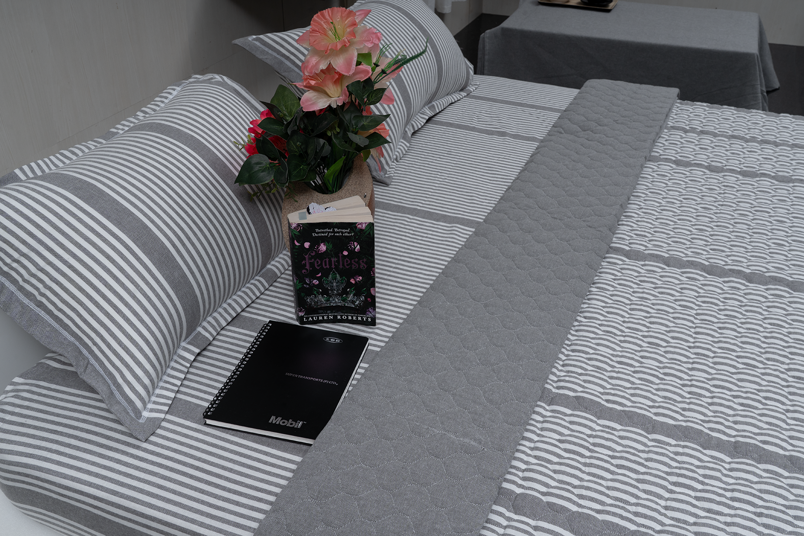 Linn Decors fitted sheet with two pillow covers and quilt styled on a modern bedroom bed